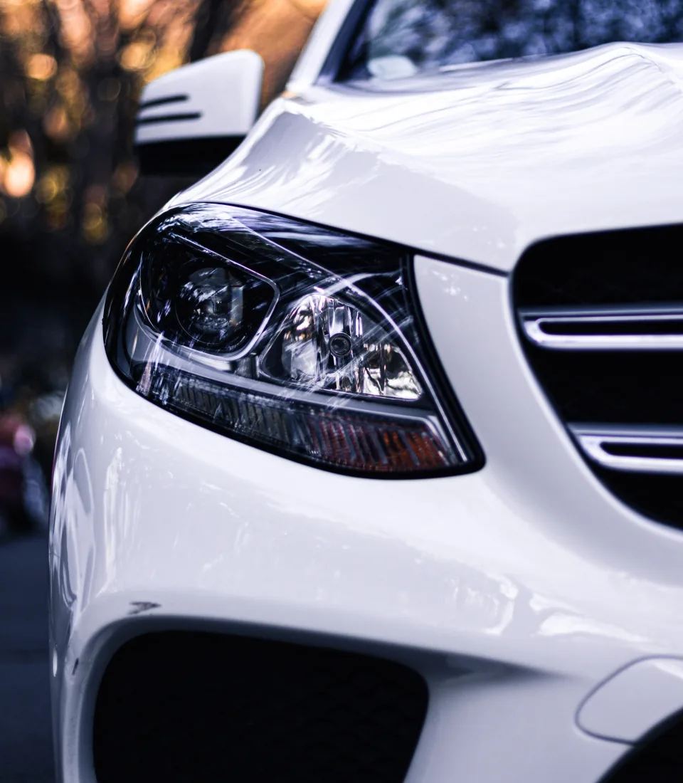 White Mercedes-Benz headlight with clear lens
